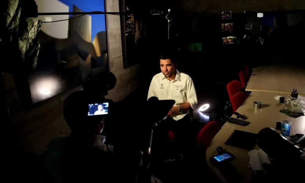Person being interviewed at a table setup Person being interviewed at a table setup