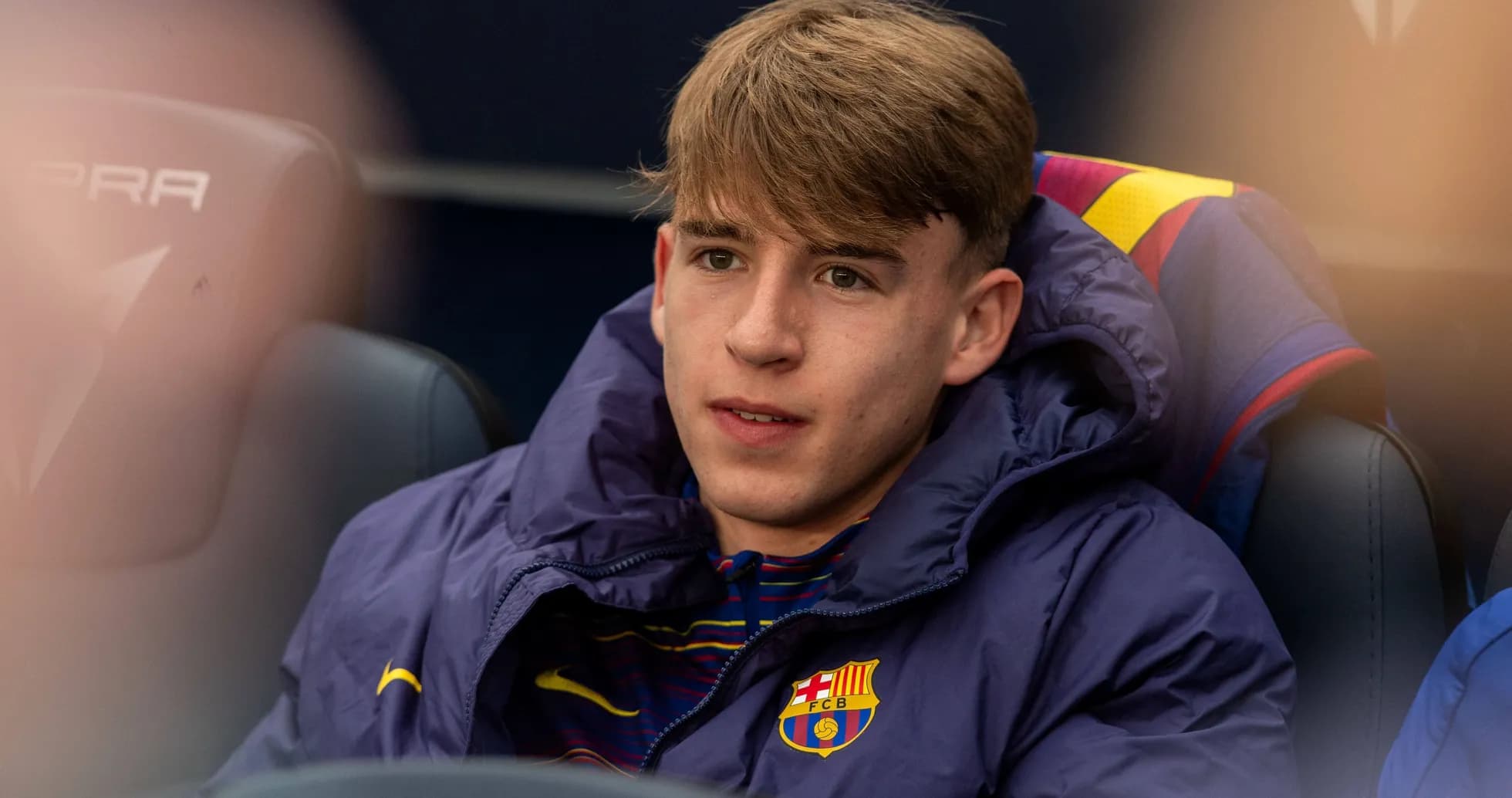 Barcelona player sitting on the bench in jacket Barcelona player sitting on the bench in jacket