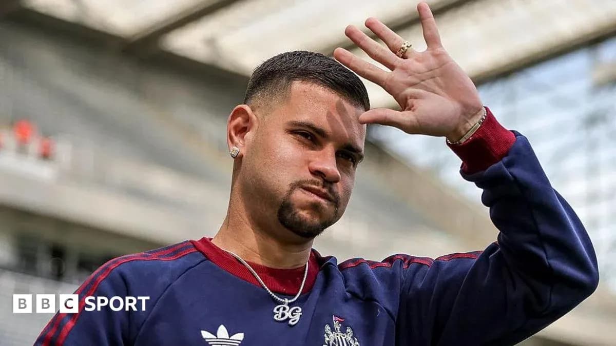 Player waving while wearing team training gear Player waving while wearing team training gear