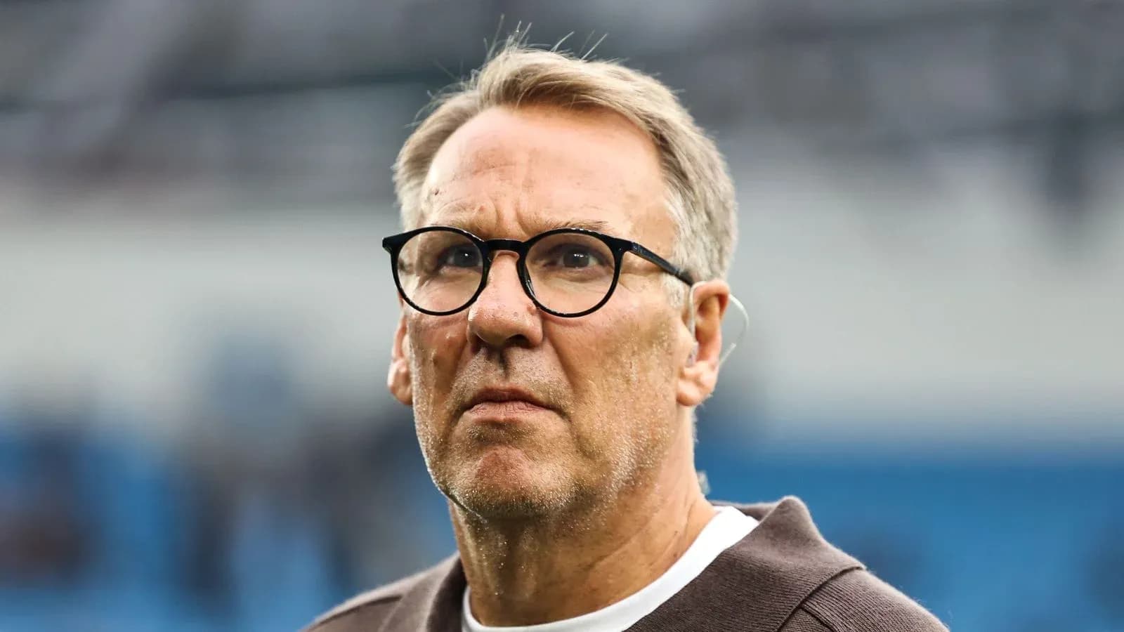 Man with glasses looking thoughtfully during event Man with glasses looking thoughtfully during event