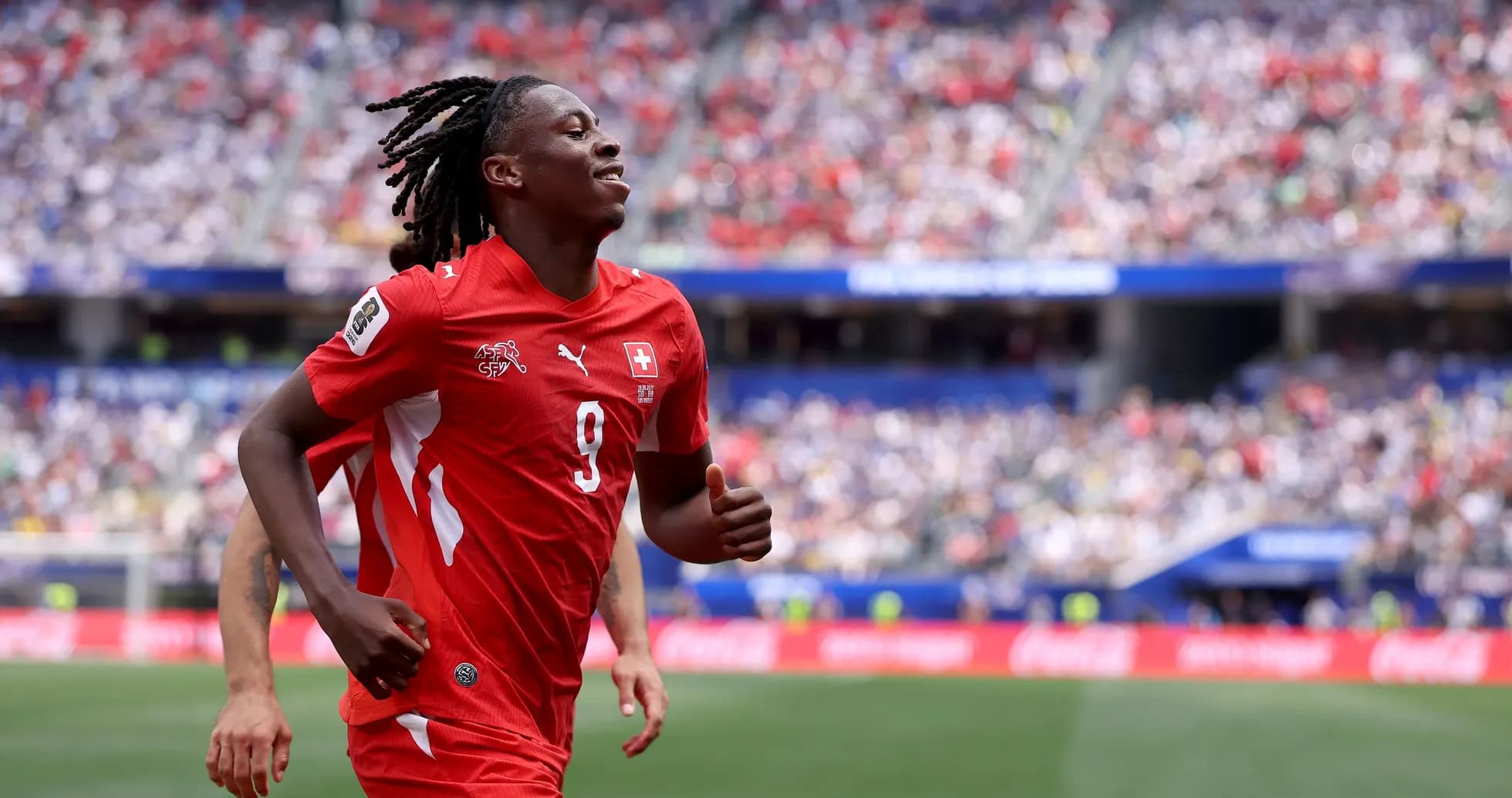 Player in red jersey running on the field Player in red jersey running on the field