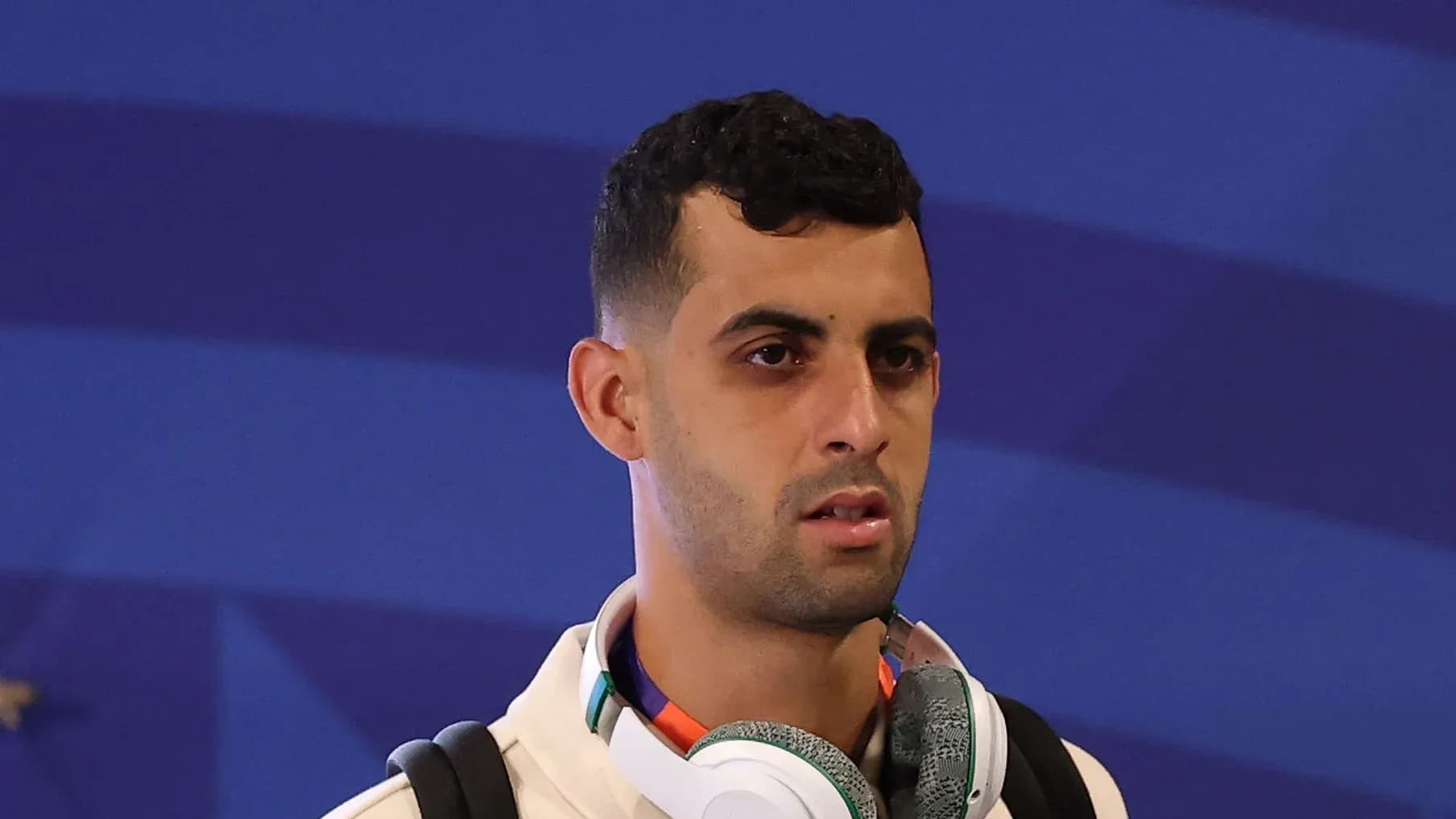 Player wearing headphones at event entrance Player wearing headphones at event entrance