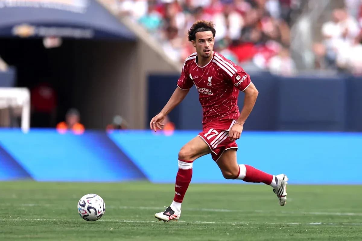 Player in Liverpool kit running with soccer ball Player in Liverpool kit running with soccer ball