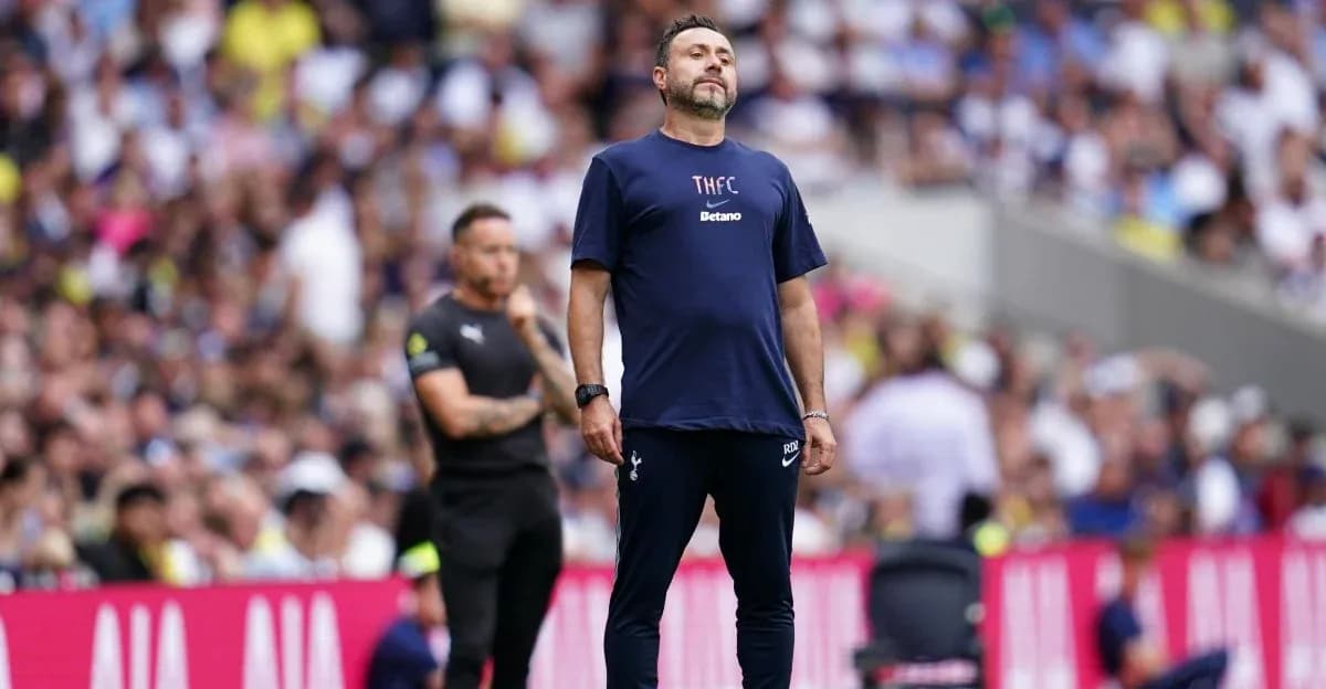 Manager observing match with fans in background Manager observing match with fans in background