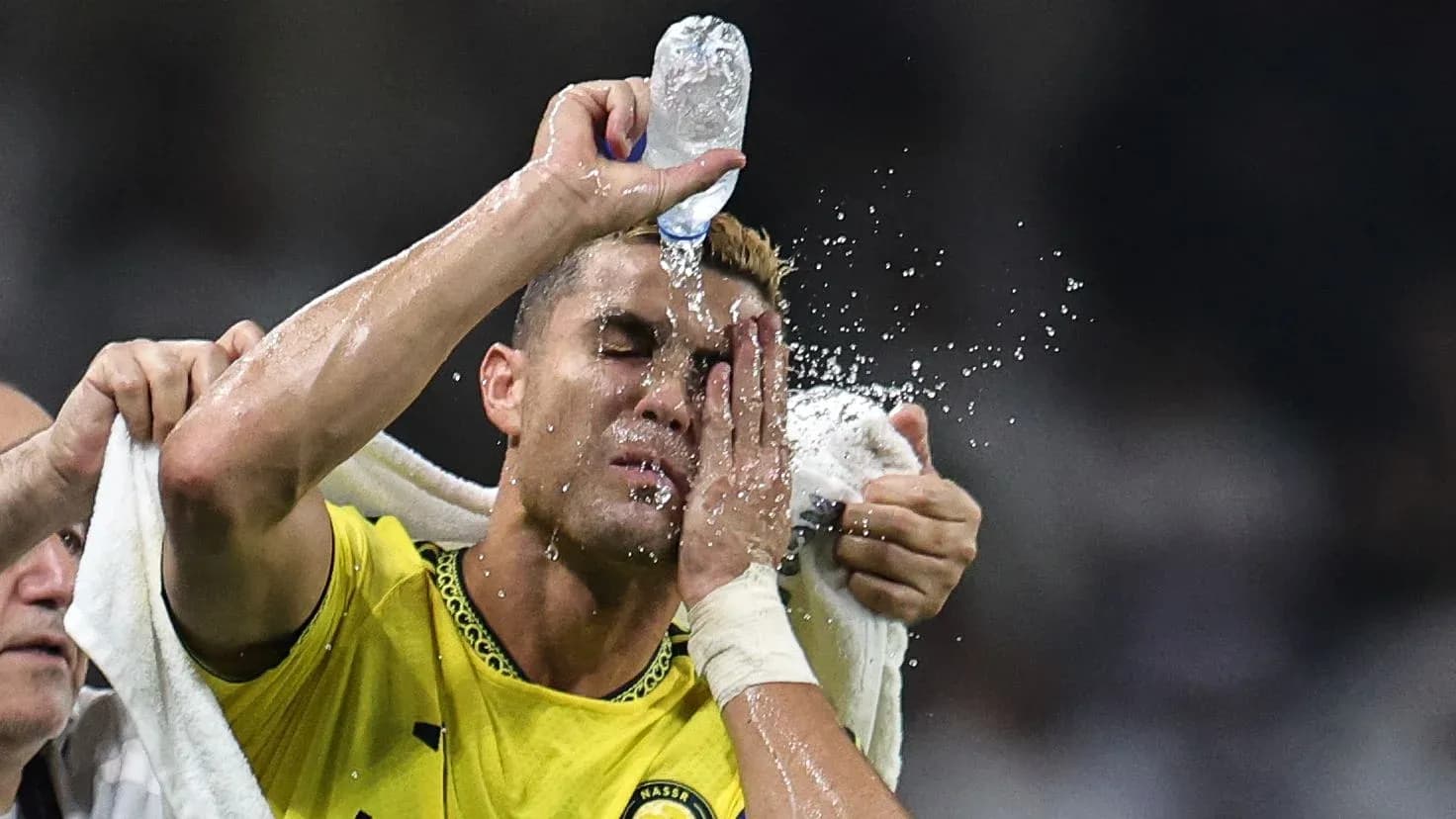 Player cooling down with water during match Player cooling down with water during match