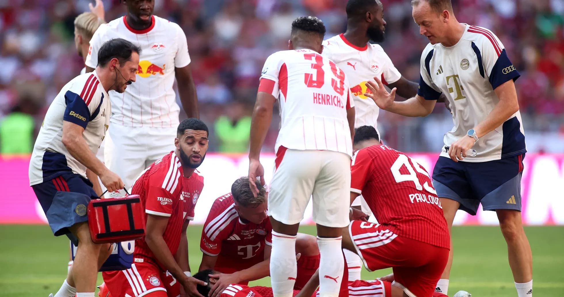 Players attending to injured teammate on the field Players attending to injured teammate on the field