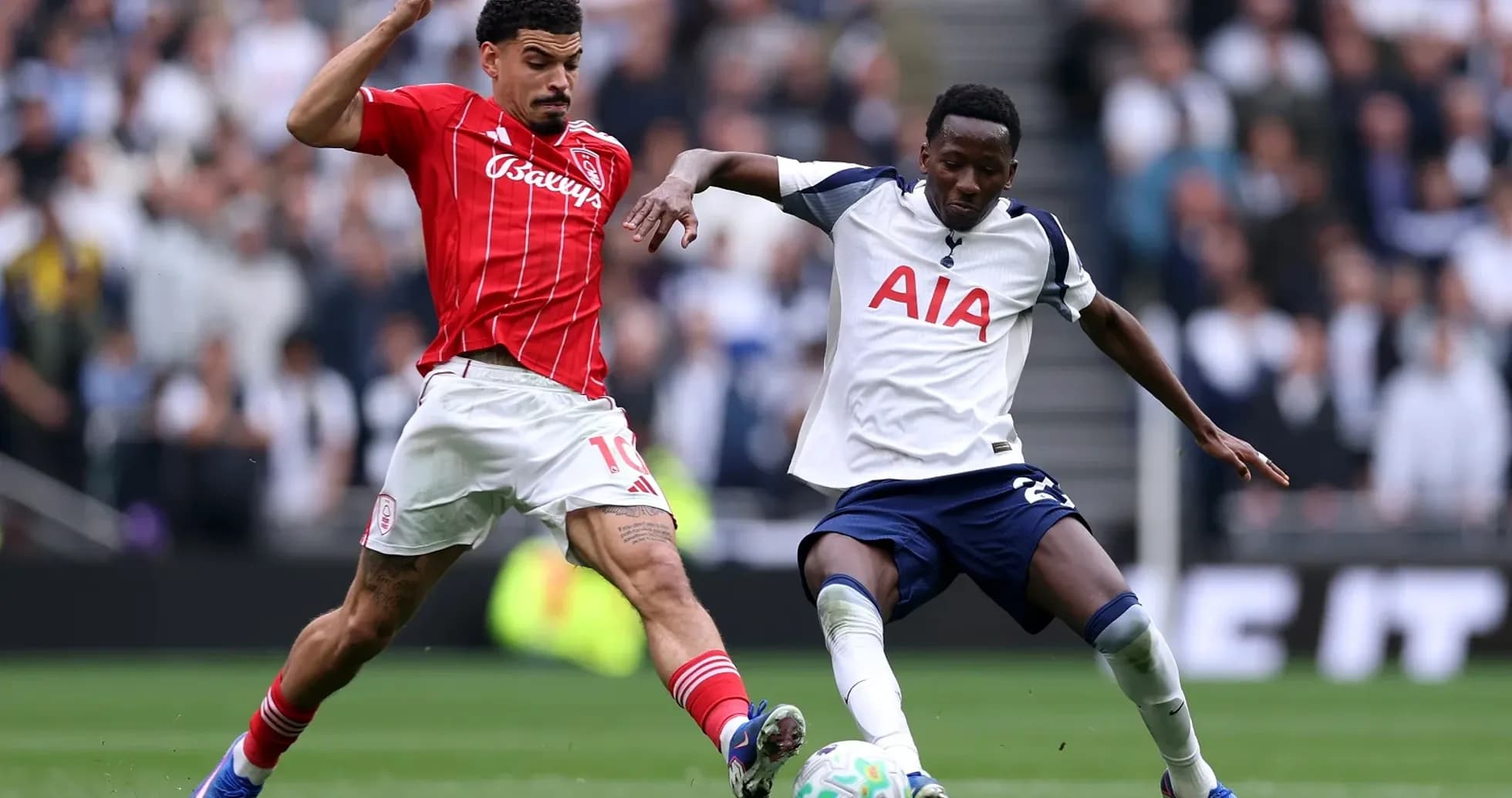 Players competing for the ball in Premier League match Players competing for the ball in Premier League match
