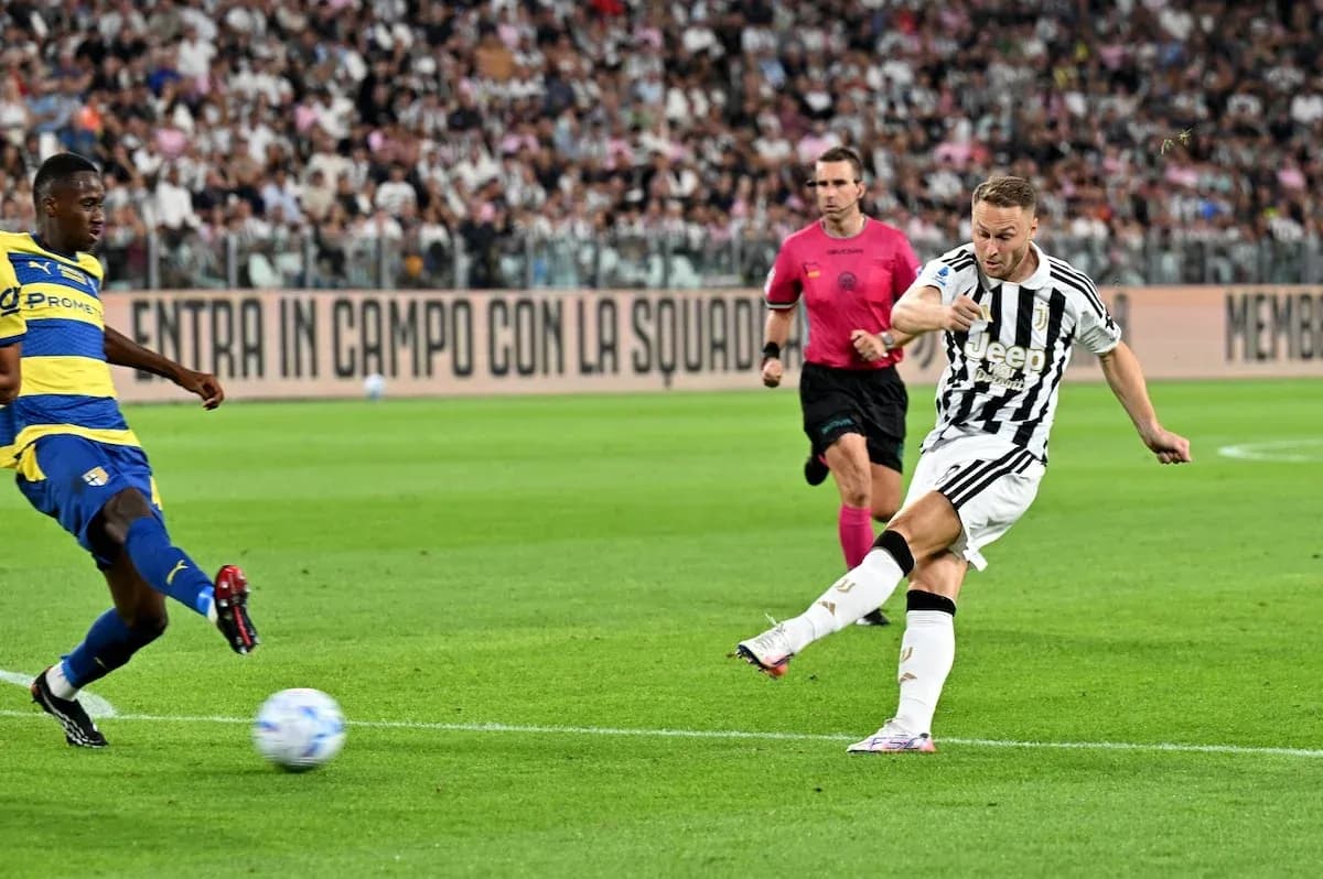 Juventus player taking a shot against Parma Juventus player taking a shot against Parma