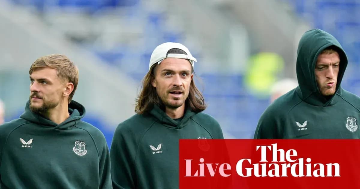 Three players walking in Everton hoodies before match Three players walking in Everton hoodies before match