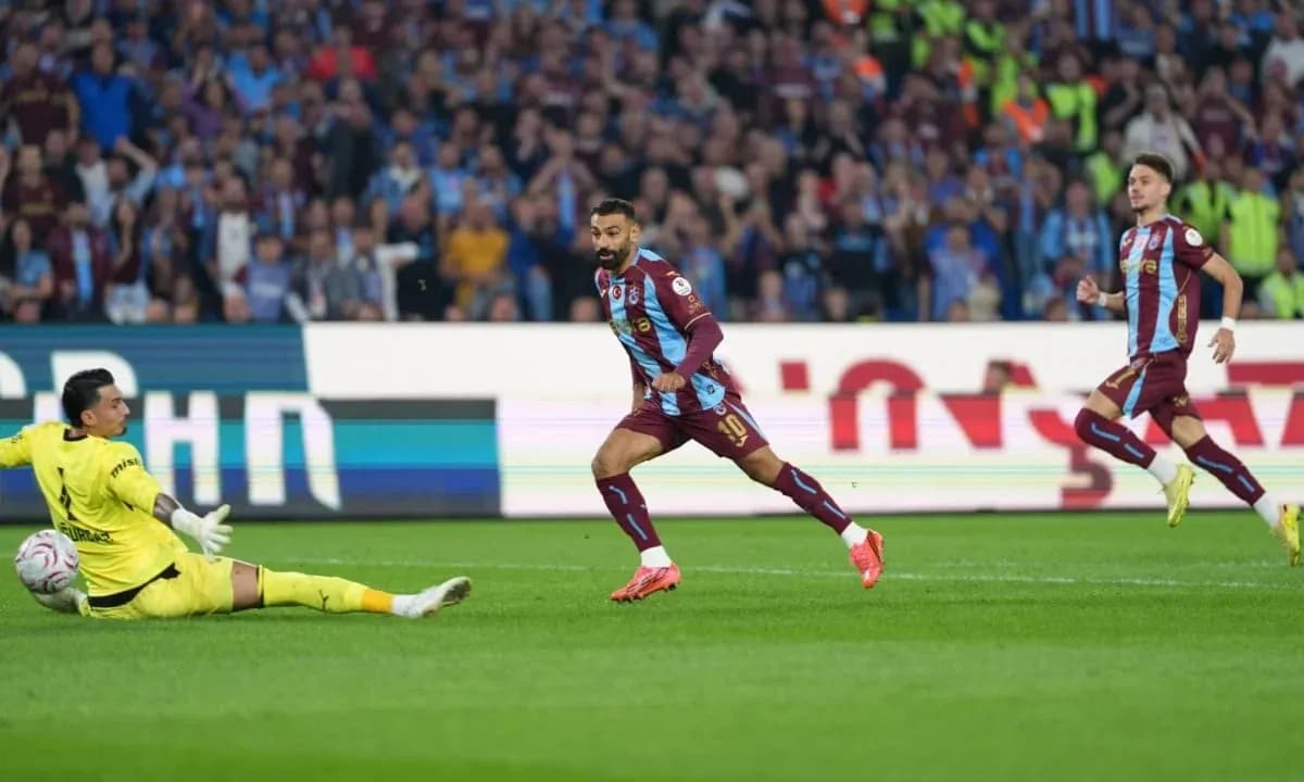 Player scoring against goalkeeper in intense match Player scoring against goalkeeper in intense match