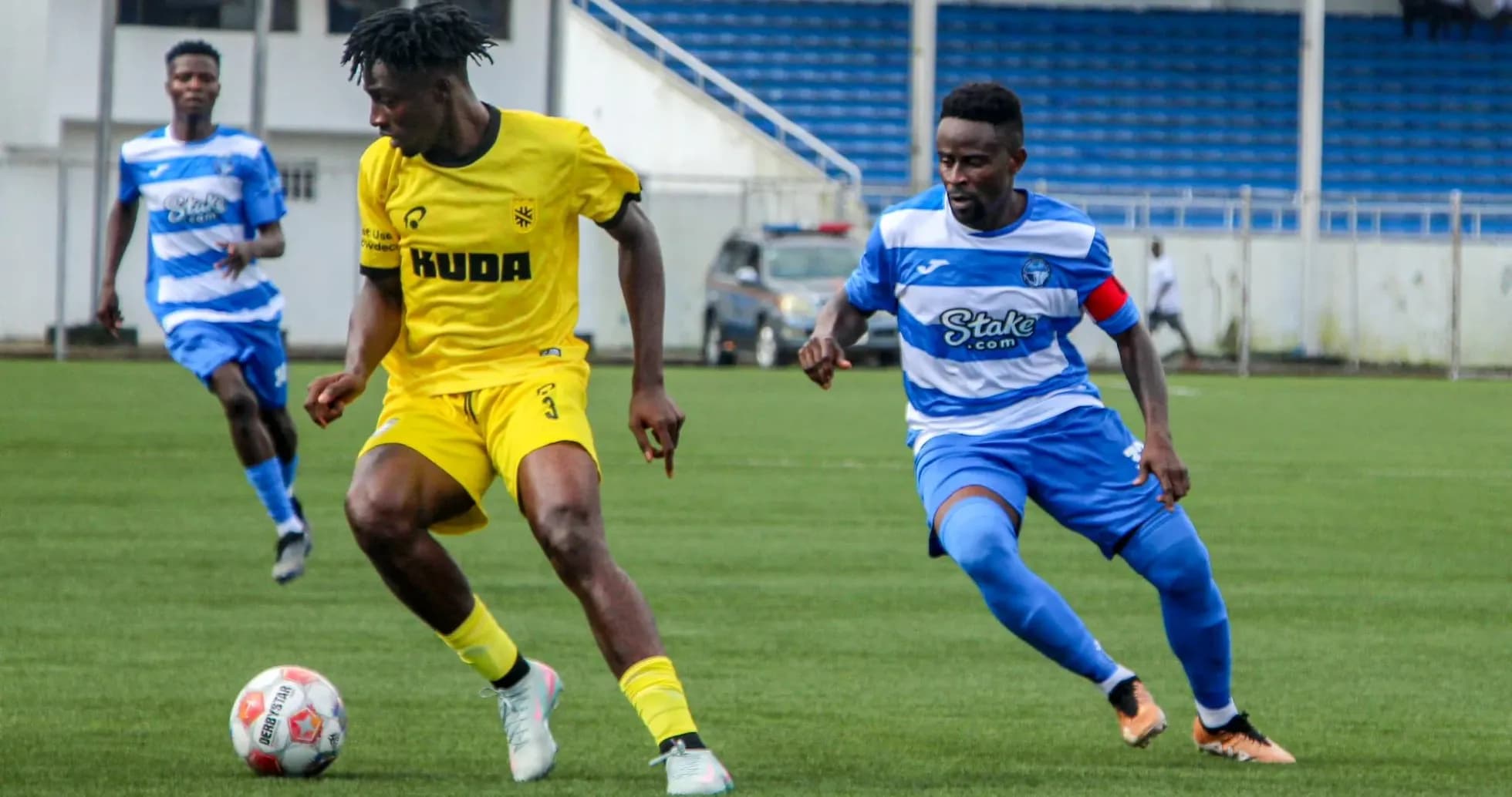 Kano Pillars player dribbling past Enyimba defender Kano Pillars player dribbling past Enyimba defender