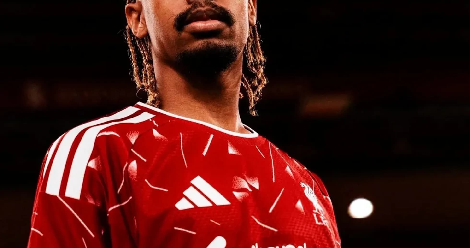 Player posing in Liverpool FC red jersey Player posing in Liverpool FC red jersey