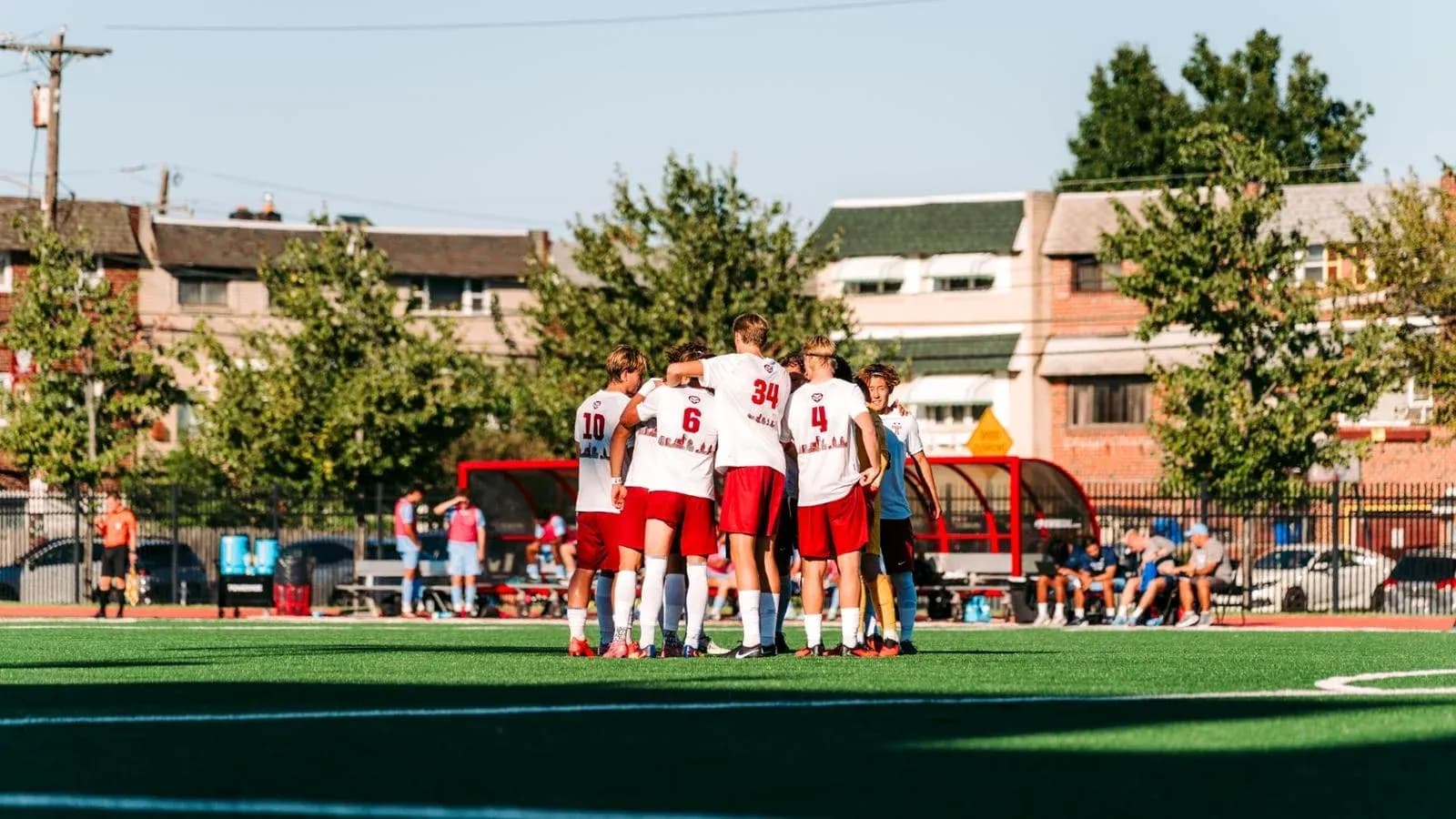 Team huddling before a soccer match on field Team huddling before a soccer match on field