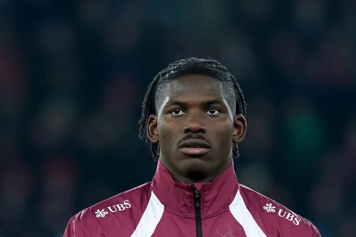 Player in maroon training jacket during match preparation Player in maroon training jacket during match preparation