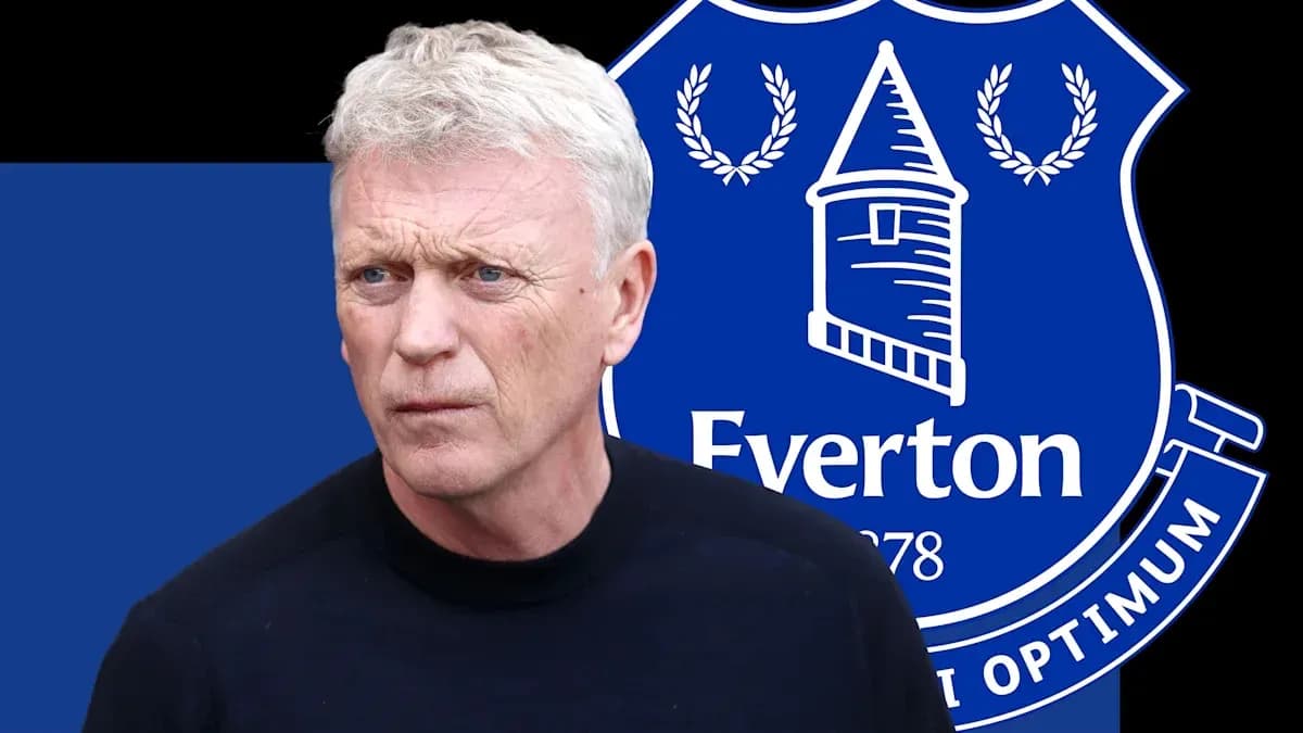 Coach in front of Everton club logo background Coach in front of Everton club logo background