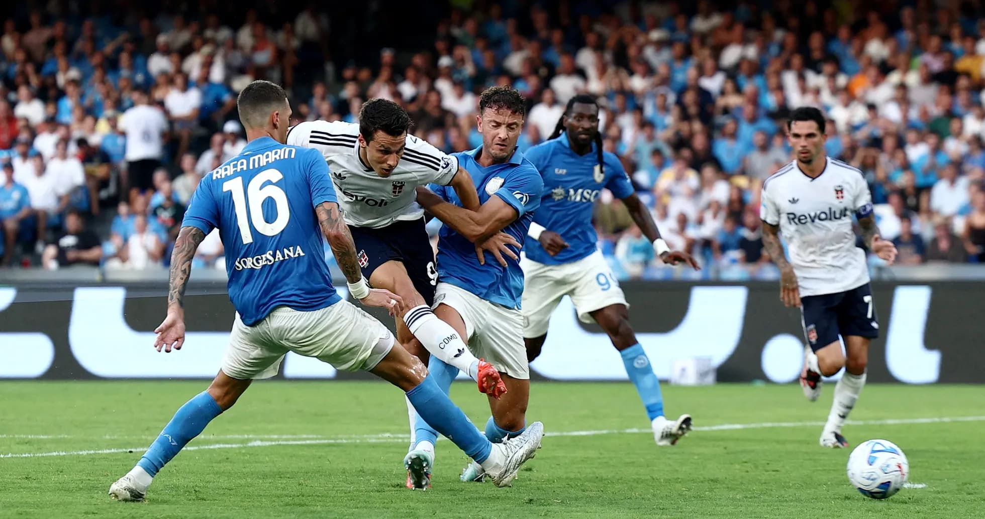 Napoli players challenging Como forward during match Napoli players challenging Como forward during match