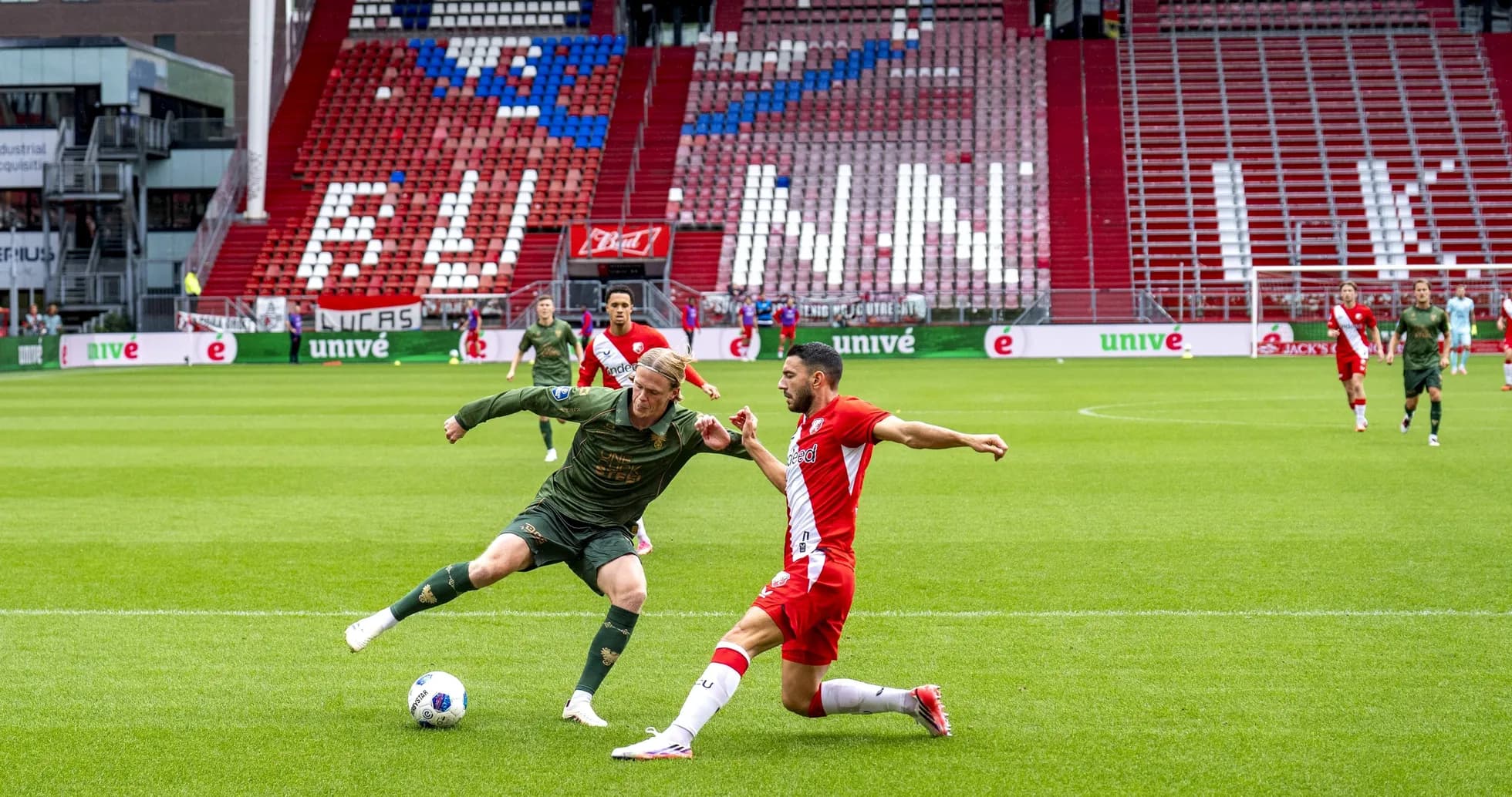 Player tackling opponent during football match on field Player tackling opponent during football match on field