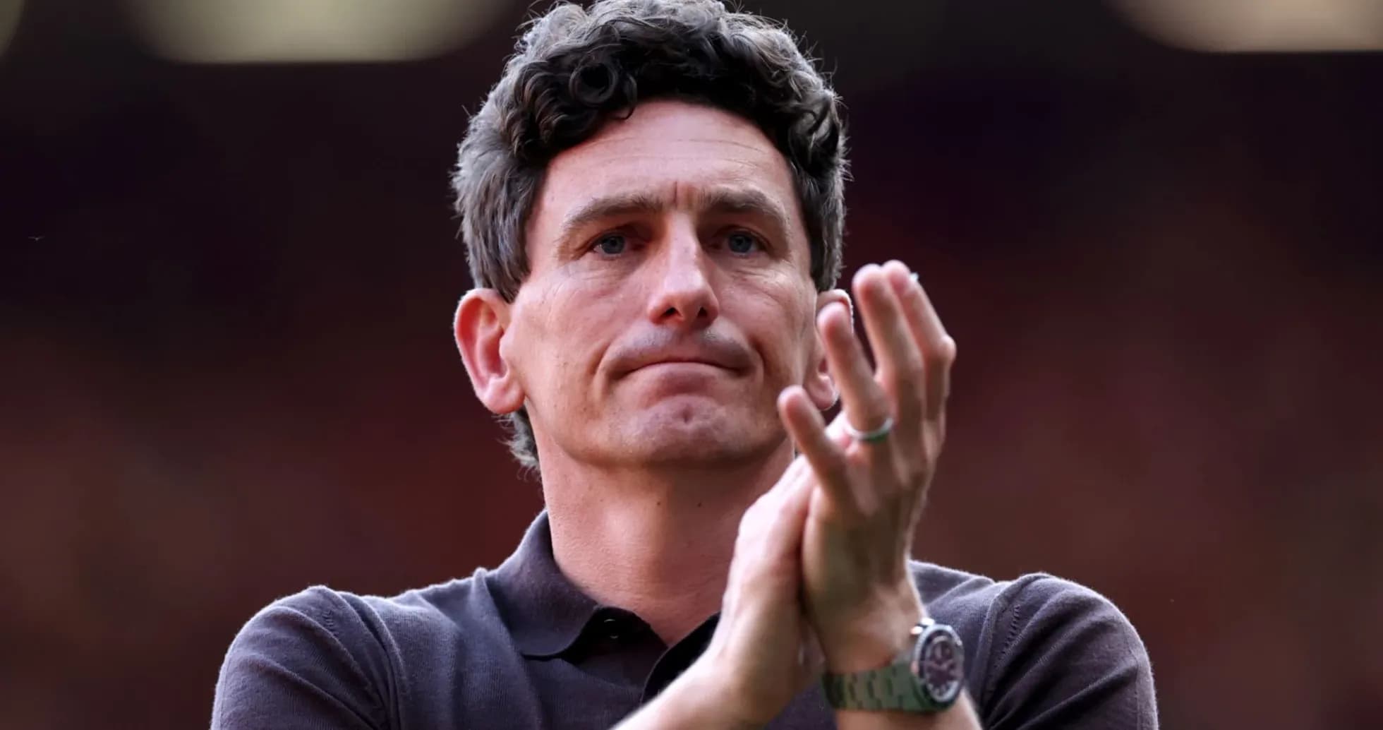 Manager applauding during match at stadium Manager applauding during match at stadium