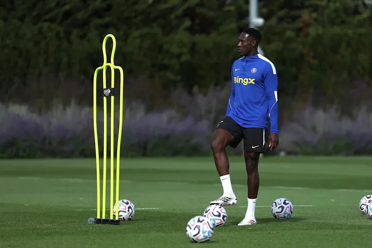 Player practicing near training cones and soccer balls Player practicing near training cones and soccer balls