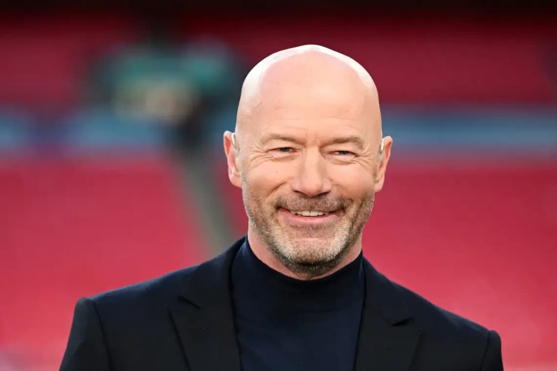 Bald man smiling in a suit at stadium Bald man smiling in a suit at stadium