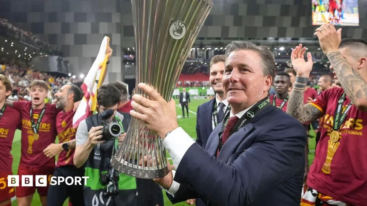 Coach holding UEFA Europa League trophy with team Coach holding UEFA Europa League trophy with team