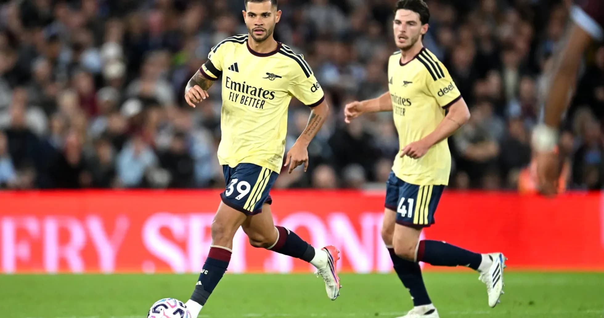 Arsenal players in yellow kits during match Arsenal players in yellow kits during match