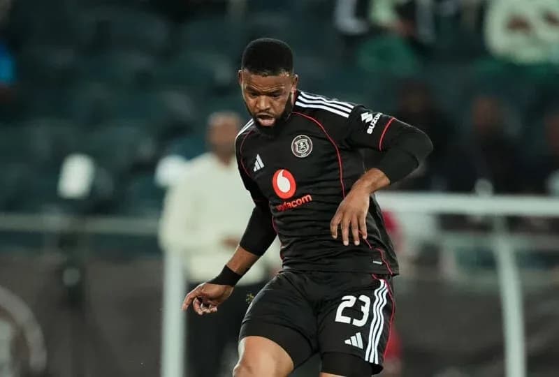 Player in black kit controlling the ball during match Player in black kit controlling the ball during match