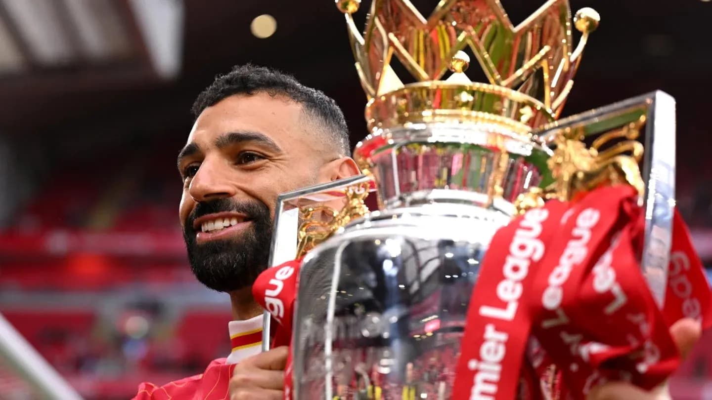 Player holding Premier League trophy in celebration Player holding Premier League trophy in celebration