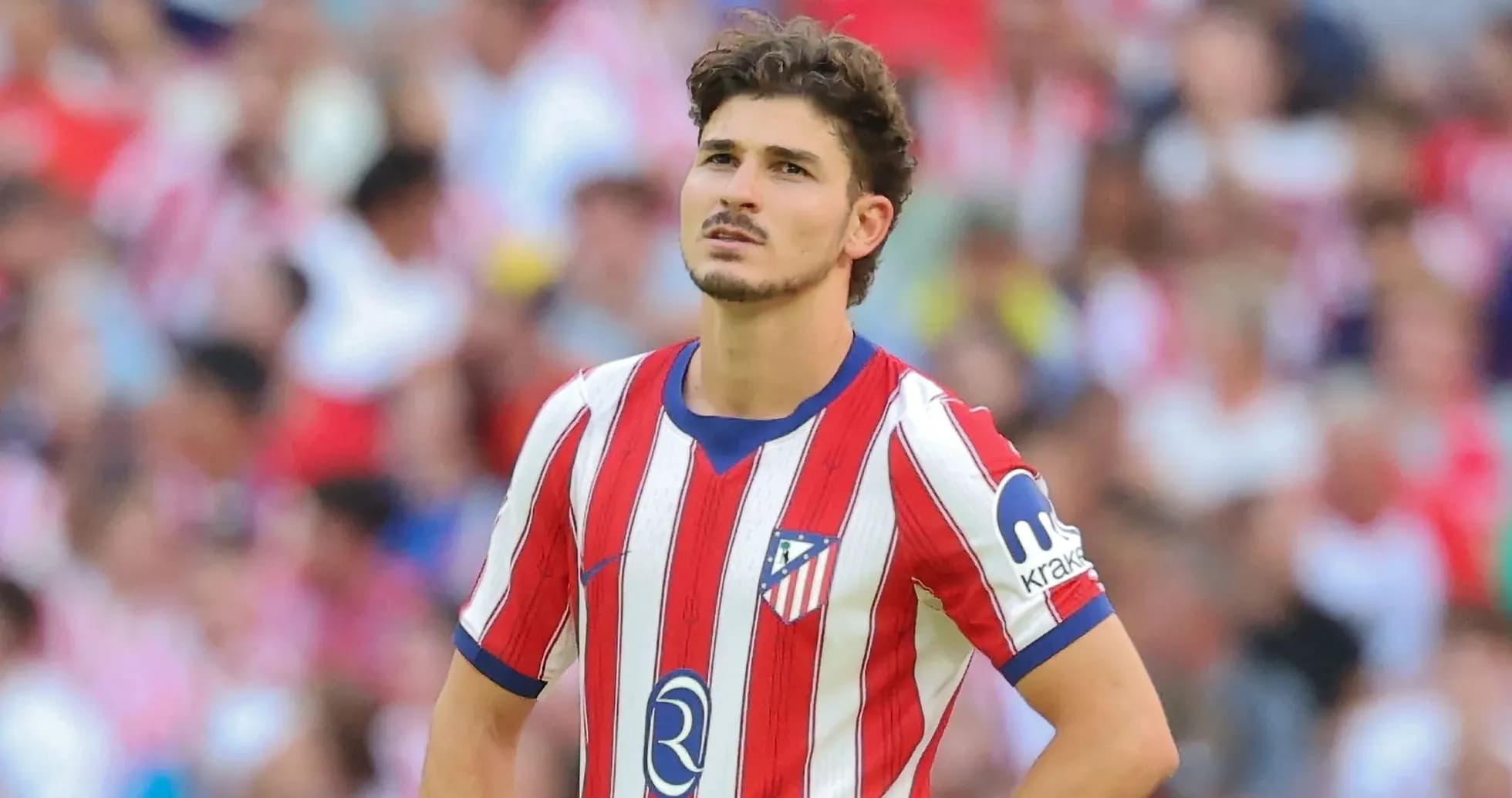 Atletico Madrid player looking thoughtful on field Atletico Madrid player looking thoughtful on field