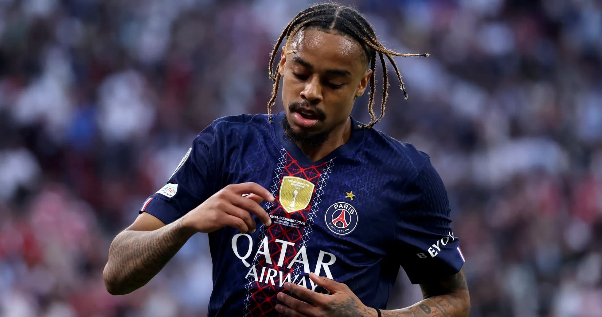 Player adjusting jersey with PSG badge during match Player adjusting jersey with PSG badge during match