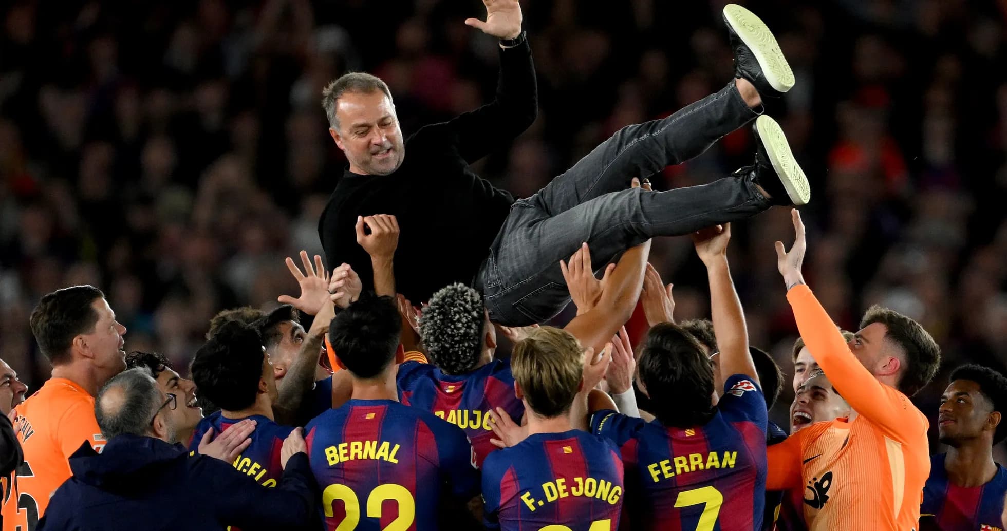 Barcelona players celebrating by lifting their coach Barcelona players celebrating by lifting their coach