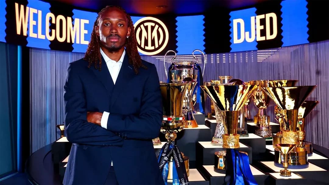 Player standing in front of trophies at unveiling Player standing in front of trophies at unveiling