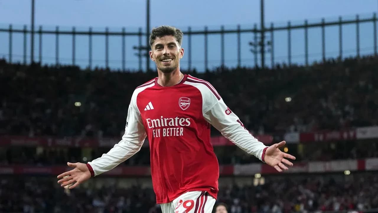 Player celebrating after scoring a goal for Arsenal Player celebrating after scoring a goal for Arsenal