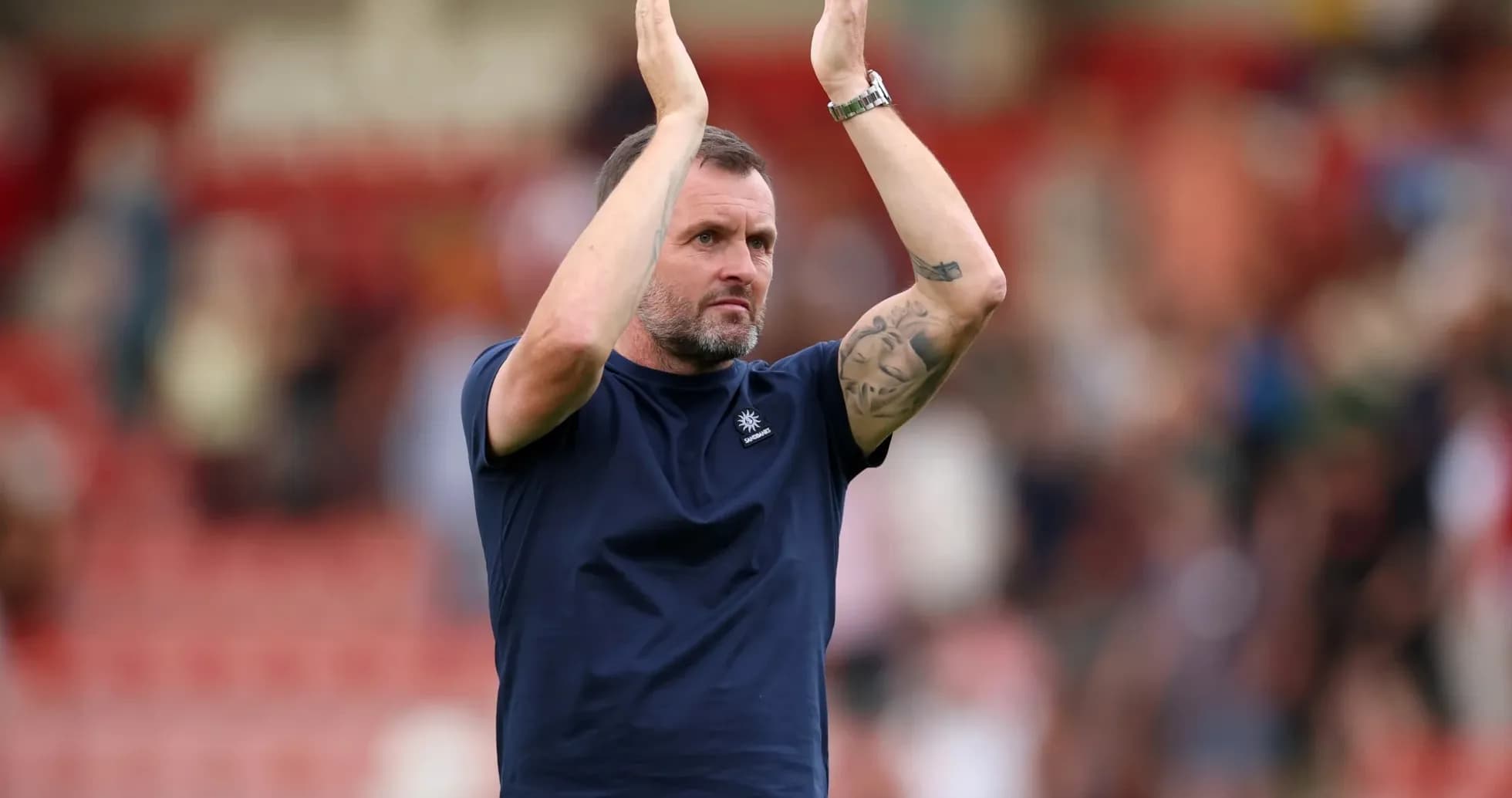 Coach applauding fans after match conclusion Coach applauding fans after match conclusion