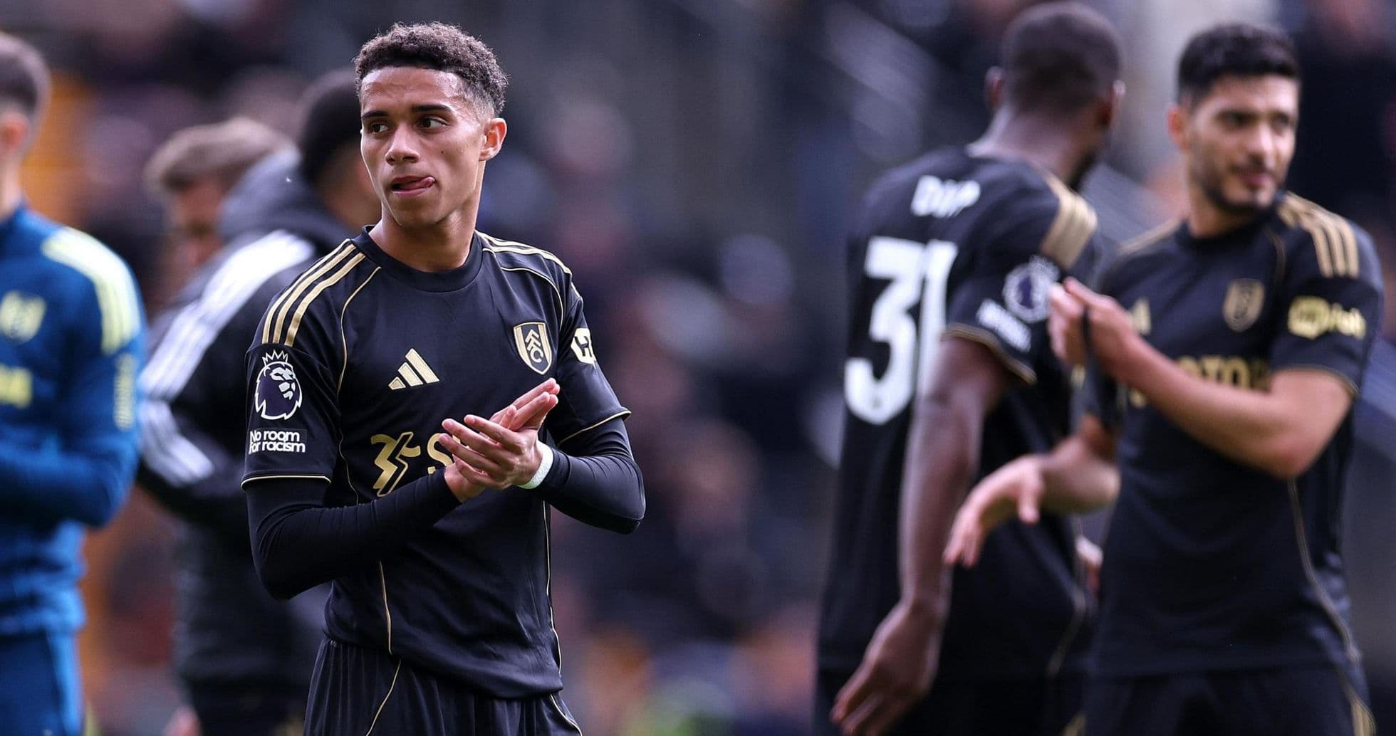 Fulham players in black kit during match Fulham players in black kit during match