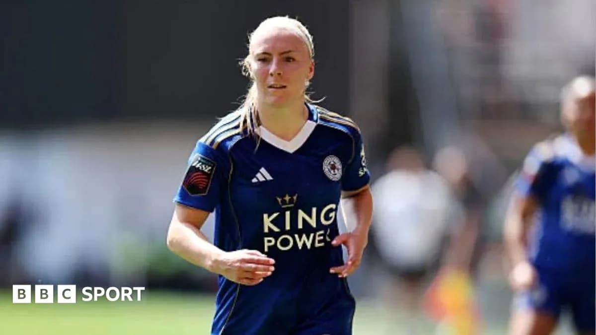 Female player in blue kit running on the field Female player in blue kit running on the field