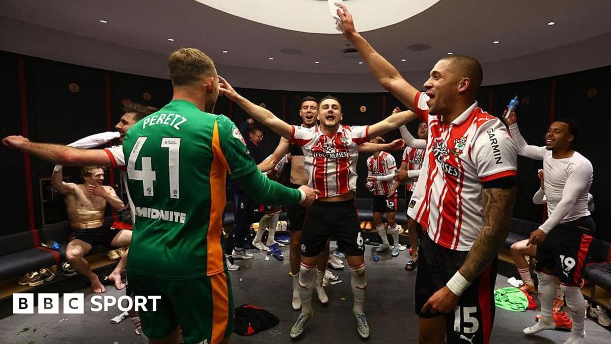 Players celebrating in locker room after match victory Players celebrating in locker room after match victory