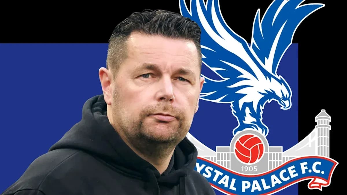 Coach in front of Crystal Palace FC logo backdrop Coach in front of Crystal Palace FC logo backdrop