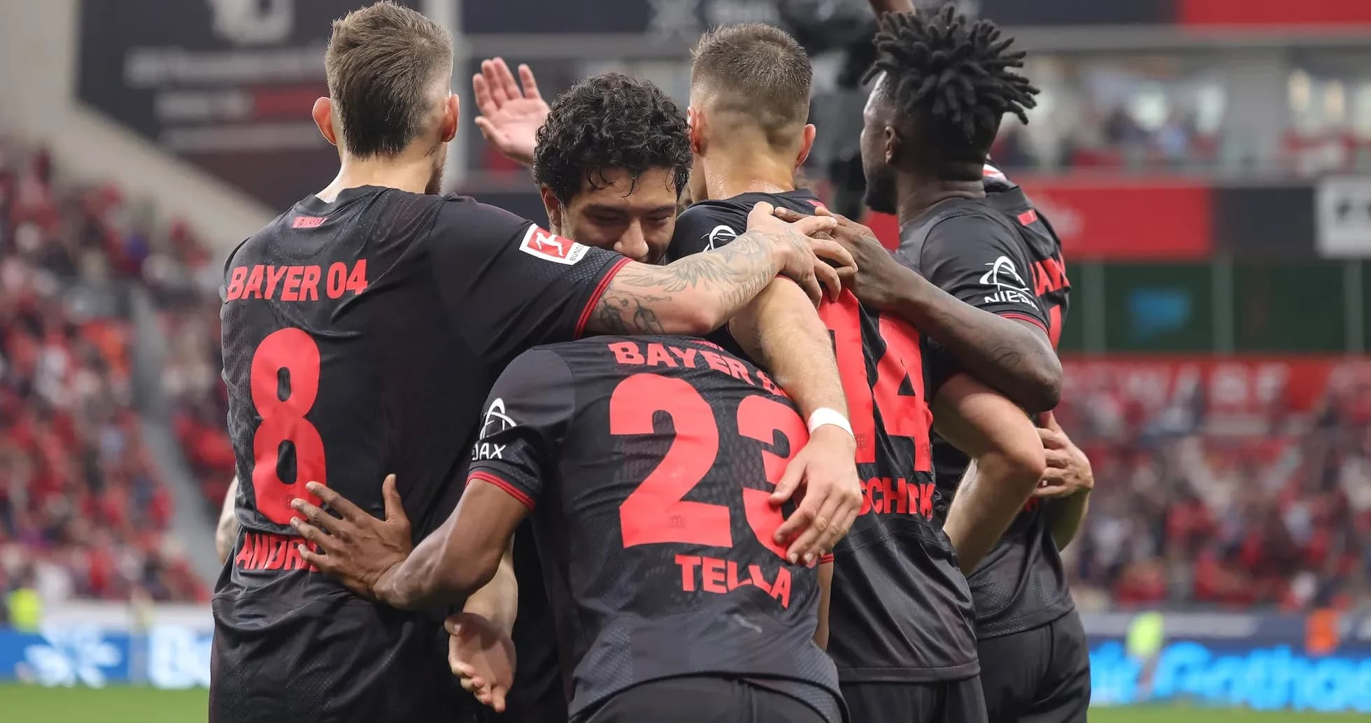 Bayer Leverkusen players celebrating a goal Bayer Leverkusen players celebrating a goal