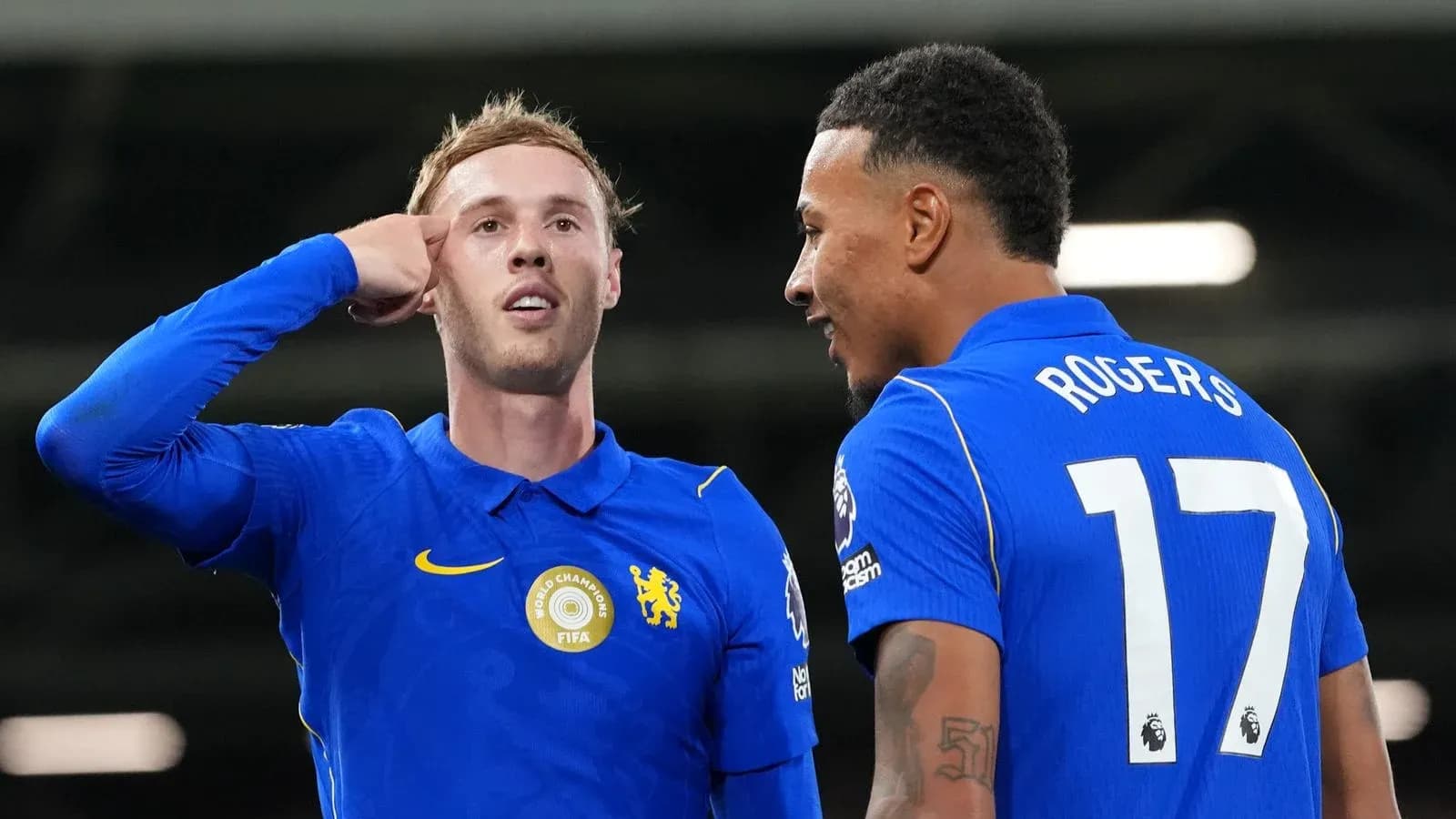 Two players celebrating after a goal on pitch Two players celebrating after a goal on pitch