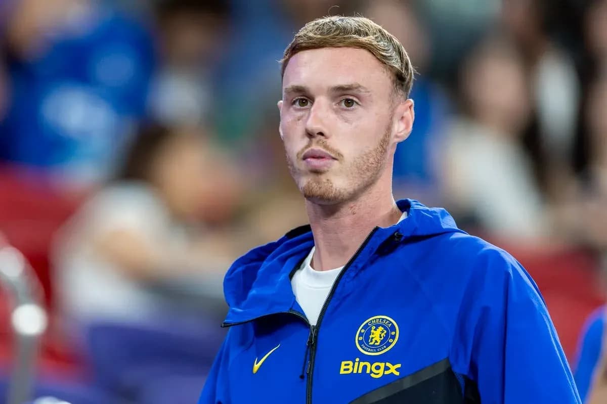 Player in Chelsea jacket on sidelines during match Player in Chelsea jacket on sidelines during match