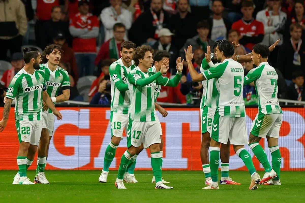 Real Betis players celebrating a goal on the field Real Betis players celebrating a goal on the field