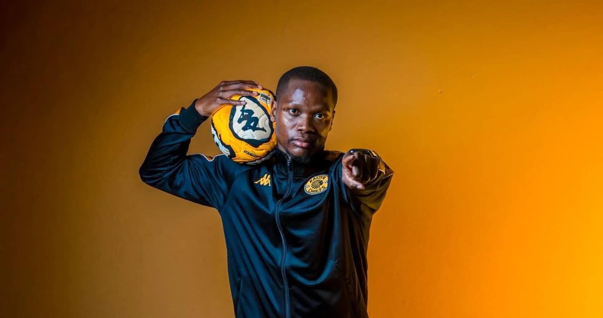 Player in Kaizer Chiefs jacket holding soccer ball Player in Kaizer Chiefs jacket holding soccer ball