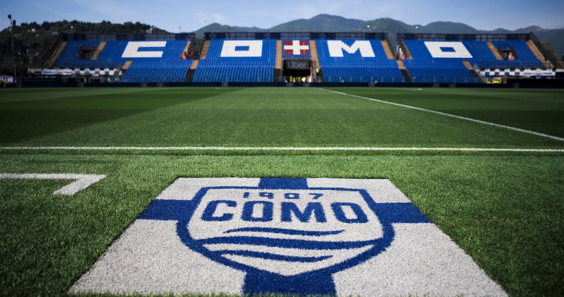 Como football stadium with club logo in foreground Como football stadium with club logo in foreground