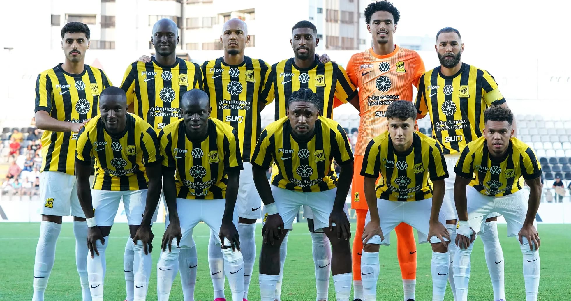 Football team posing for a group photo before match Football team posing for a group photo before match