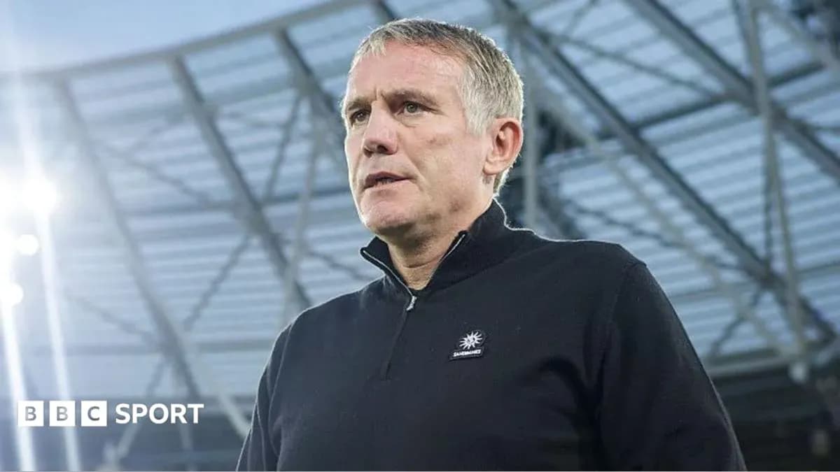 Coach standing in stadium before match Coach standing in stadium before match