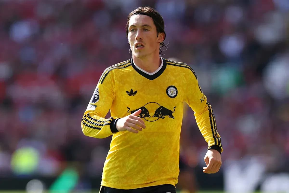Player in yellow kit running on the field Player in yellow kit running on the field