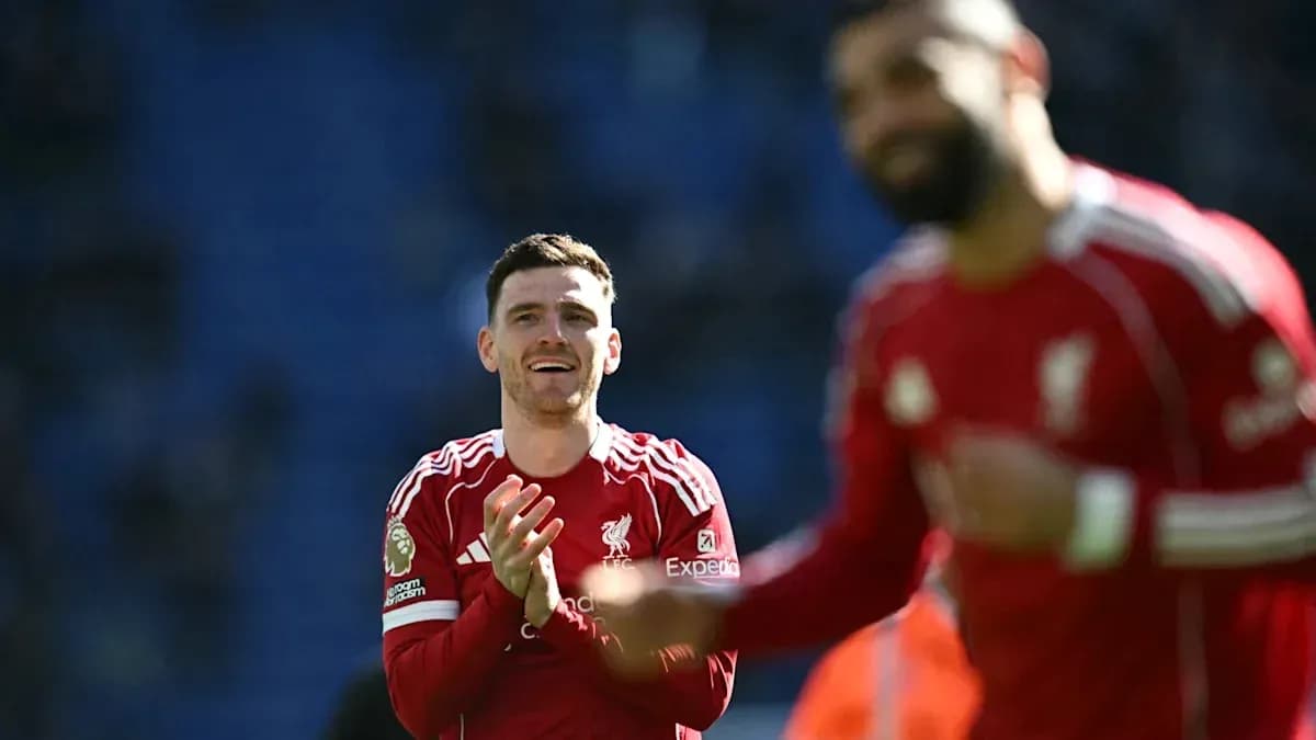 Two Liverpool players celebrating on the pitch Two Liverpool players celebrating on the pitch