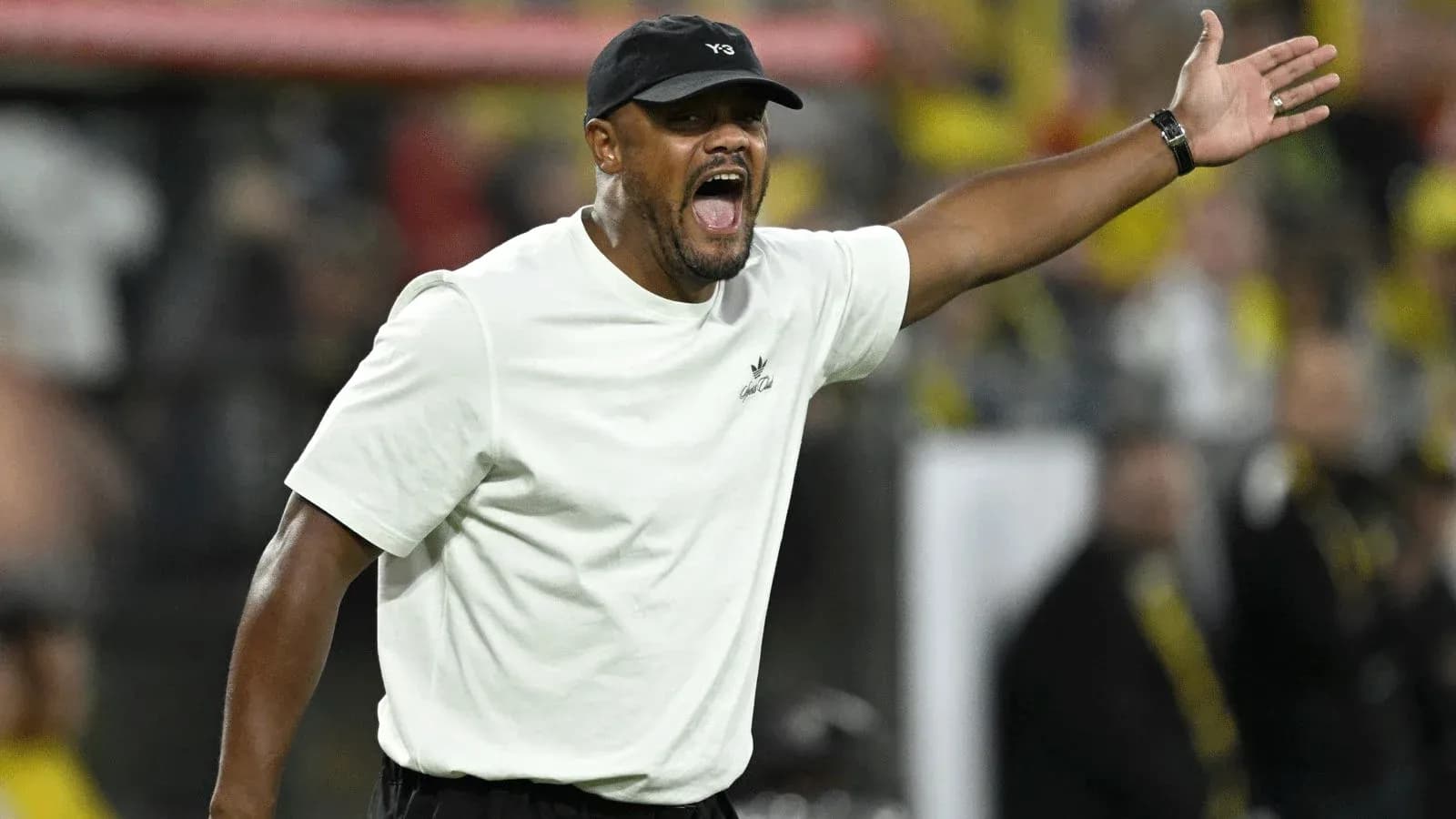 Coach gesturing during a football match on the sidelines Coach gesturing during a football match on the sidelines