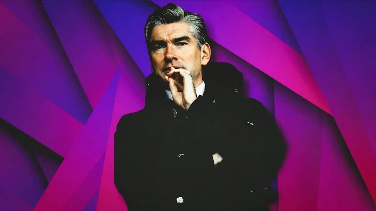 Man in coat with hand to mouth against colorful background Man in coat with hand to mouth against colorful background